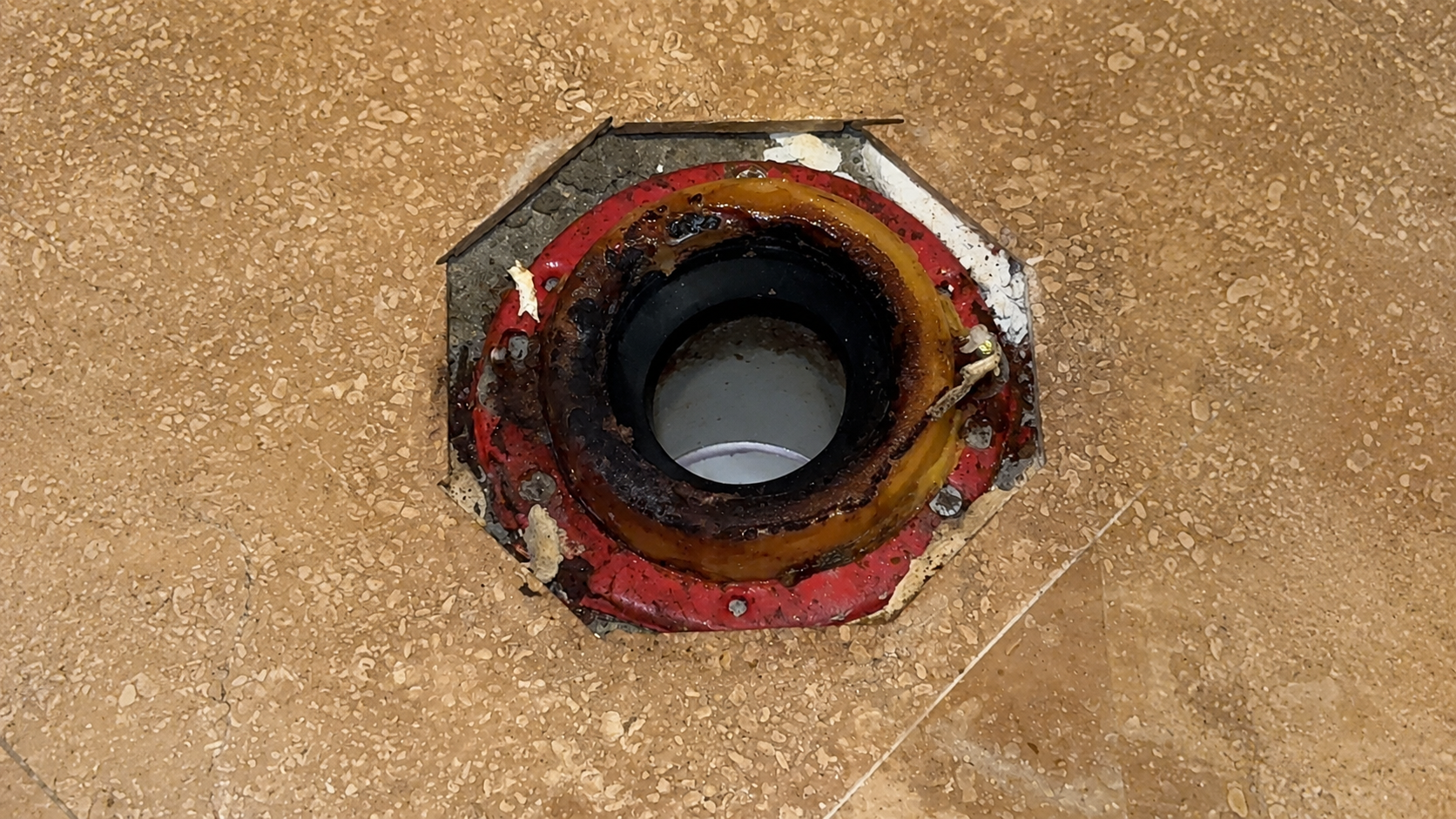Damaged toilet connection before repair