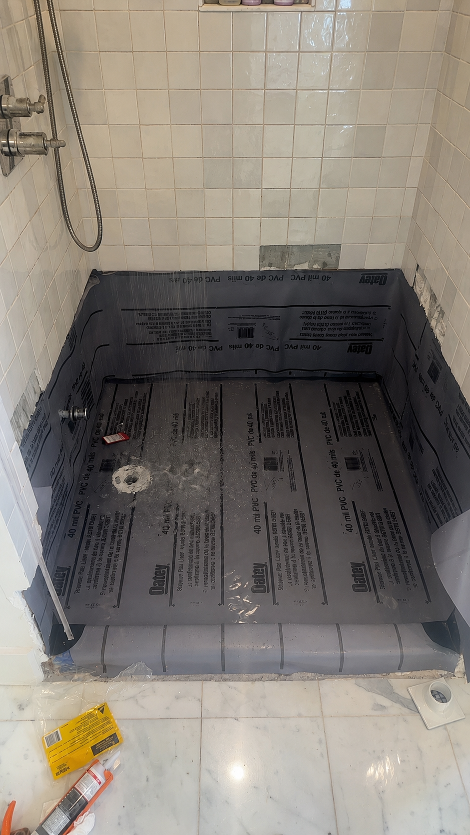 Waterproof shower pan liner installed around a new shower drain